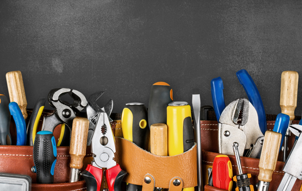 Tool belt with tools on wooden background